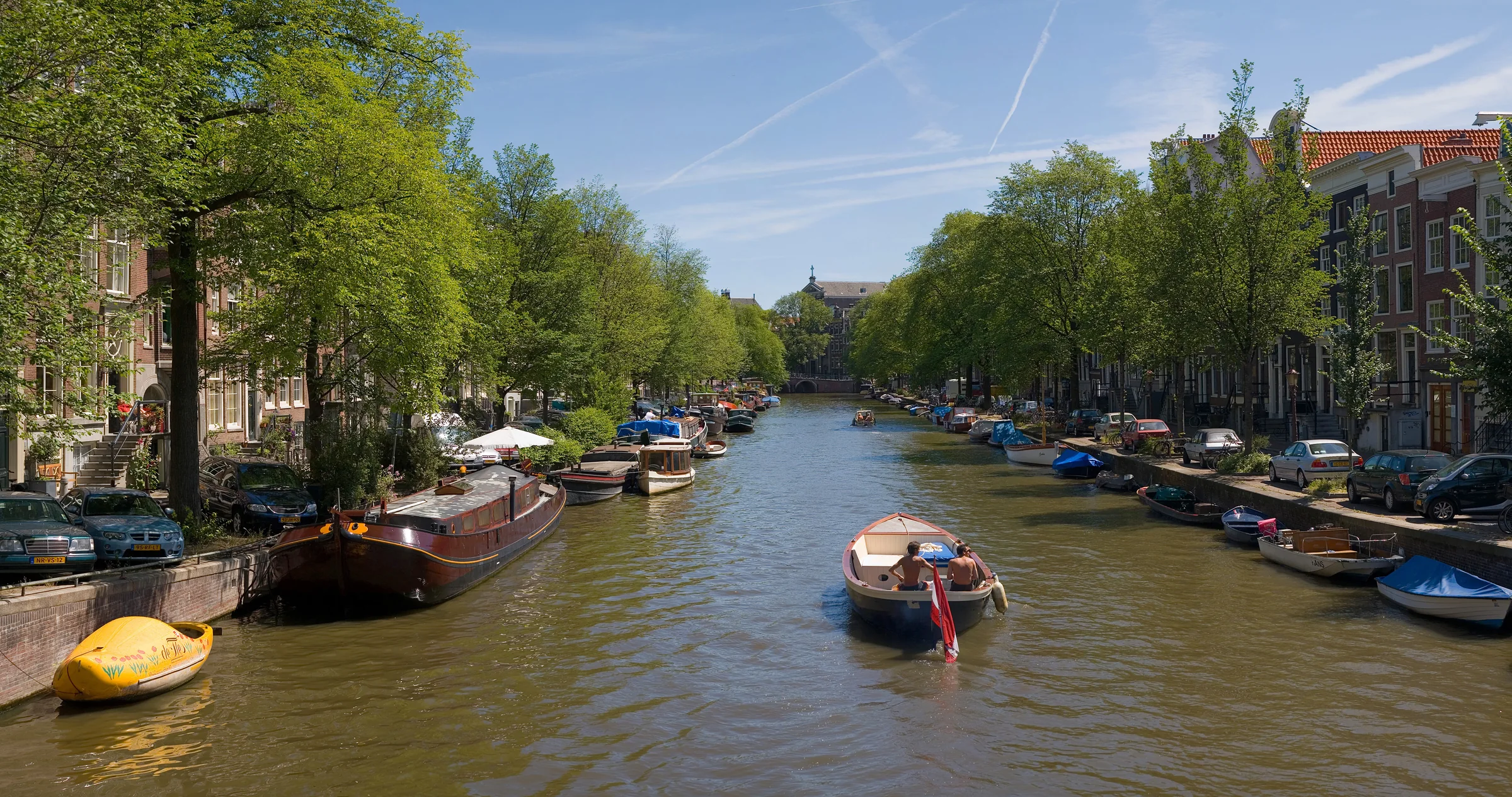 Amsterdam canal houses and water on a summer day